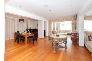 a dining room and living room with a table and chairs at Cape Serenity Mansion in Ayia Napa