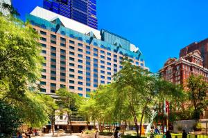 a large building in a city with trees in front at The Westin Philadelphia in Philadelphia