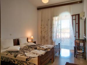 a bedroom with two beds and a window at Tria Adelphia in Arillas +97 photos