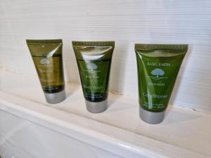 three bottles of face cream on a shelf at Incredible Private Rooms All with Private Bathrooms in a Fully Serviced House next to City Centre with Free Parking in Coventry
