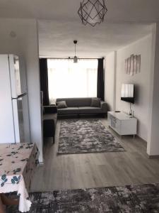 a living room with a couch and a table at Backyard Apart in Kemer
