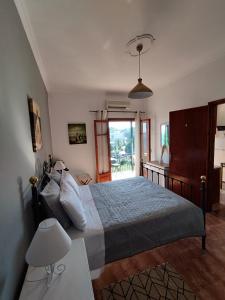 a bedroom with a bed and a desk in it at Teo & Niki in Paleokastritsa