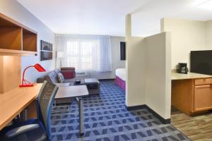 a hotel room with a kitchen and a living room at TownePlace Suites Minneapolis-St. Paul Airport/Eagan in Eagan