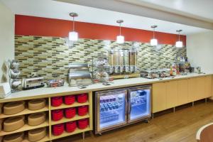 a restaurant with a counter with red bowls on it at TownePlace Suites Minneapolis-St. Paul Airport/Eagan in Eagan