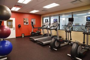 a gym with treadmills and exercise bikes in a room at TownePlace Suites by Marriott Lawrence Downtown in Lawrence