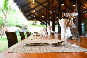 a long wooden table with a glass vase on it at Avatar Railay in Railay Beach