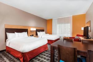 a hotel room with two beds and a desk at TownePlace Suites by Marriott Orlando Altamonte Springs/Maitland in Orlando