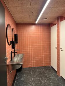 a bathroom with a sink and a mirror at City Hostel Bergen in Bergen