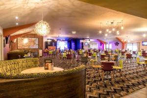 a restaurant with chairs and tables and a bar at Holiday home in Dymchurch - New Beach Holiday Park in Dymchurch