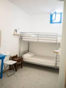 a room with two bunk beds and a table at Amorgos Azur apartment in Tholária