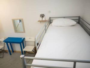 a bedroom with a bed and a blue table at Amorgos Azur apartment in Tholária