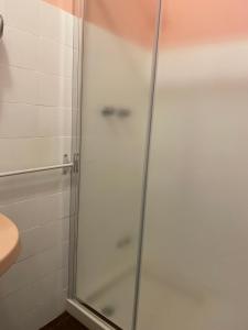 a shower with a glass door in a bathroom at Alabe Hotel in Tresnuraghes