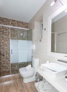 a bathroom with a toilet and a sink at Verga's Apartments in Kalamata