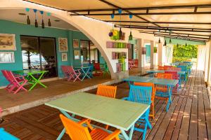 a restaurant with colorful tables and chairs on a deck at Sea View Apartments - Aheloy in Ravda