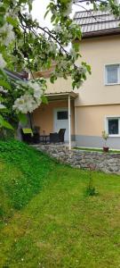a house with a garden with a piano in the yard at Apartma B & O in Idrija