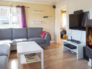 a living room with a couch and a tv at 4 person holiday home in Fjällbacka-By Traum in Fjällbacka