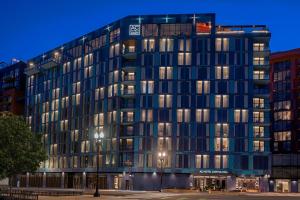 a tall building with many windows at night at AC Hotel by Marriott Washington DC Capitol Hill Navy Yard in Washington