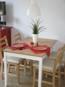a wooden table with red napkins and plates on it at Appartementhaus Lengsdorf in Maurach