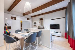 a kitchen and dining room with a table and chairs at ALTAI Annecy Rent Lodge in Annecy