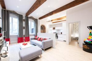 a living room with a couch and a table at ALTAI Annecy Rent Lodge in Annecy