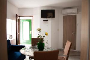a living room with a table with a vase of flowers on it at Amber in the centar in Kaštela