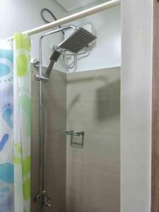a shower with a shower head in a bathroom at Shore 2 Staycation - Near Mall of Asia and Casinos in Manila