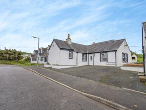 a white house sitting on the side of a street at Ben Ma Cree in Portpatrick