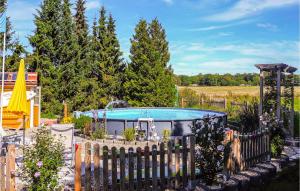 a swimming pool in a yard with a fence at Pet Friendly Apartment In Sehlen With Wifi in Sehlen