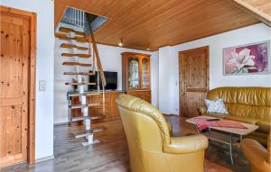 a living room with a couch and a spiral staircase at Pet Friendly Apartment In Sehlen With Wifi in Sehlen