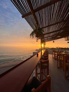 a bar with a view of the ocean at sunset at Casablanca del Mar in Punta Hermosa