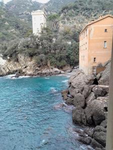 a river with a building on the side of a mountain at Casa dell'Arco Civico 35 in San Fruttuoso
