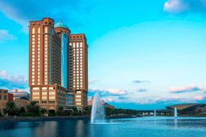 a view of a fountain in front of two buildings at Sheraton Mall of the Emirates Hotel, Dubai in Dubai