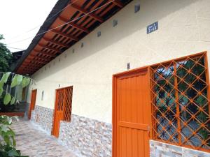 an orange door on the side of a building at La Posada Del Coyote in Ortega