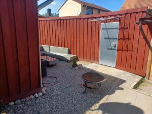 a patio with a bench and a table next to a fence at Zum alten Schmied Vermietung und Verpachtung Schönfeld 