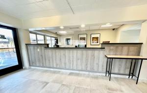 an empty waiting room with a counter and tables at Inn of Sheboygan in Sheboygan