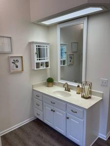 a white bathroom with a sink and a mirror at Country Villa pool hot tub game room pond in Jacksonville
