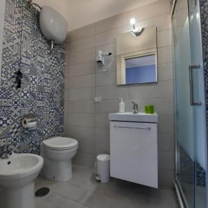 a bathroom with a toilet and a sink and a mirror at Casa Signorile in Pompei +97 photos
