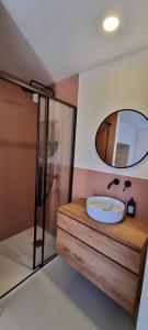a bathroom with a sink and a mirror at Appartement au centre du village in Cargèse