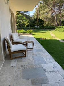 a patio with two chairs and a table at The Bee House in San Giovanni