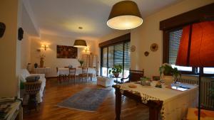 a living room with a table and a dining room at Terre del Sud in Locri