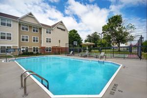 a swimming pool in front of a building at Residence Inn Louisville Airport in Louisville