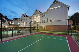 a tennis court in front of a building at Residence Inn Louisville Airport in Louisville