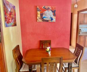 a dining room with a wooden table and chairs at Joli appartement a la corniche de Tanger in Tangier