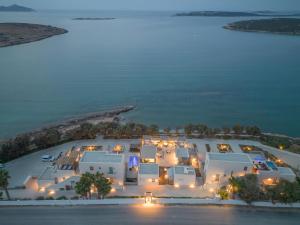 an aerial view of a resort at night with the ocean at Paros Comfy Suites in Naousa