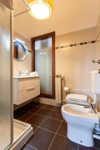 a bathroom with a toilet and a sink and a shower at A central quiet sunny studio in Verbania in Verbania