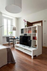 a living room with a large white entertainment center at A central quiet sunny studio in Verbania in Verbania