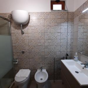 a bathroom with a toilet and a sink at Casa Signorile in Pompei