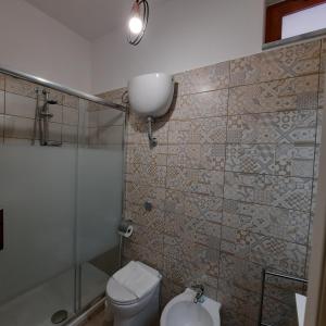 a bathroom with a shower and a toilet and a sink at Casa Signorile in Pompei
