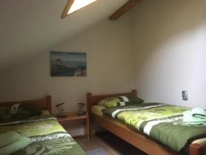 a bedroom with two twin beds and a bridge at Guest House Josipović in Korenica