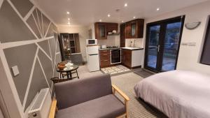 ein Schlafzimmer mit einem Bett und einem Stuhl in einem Zimmer in der Unterkunft Rear of Levett Gardens in Seven Kings